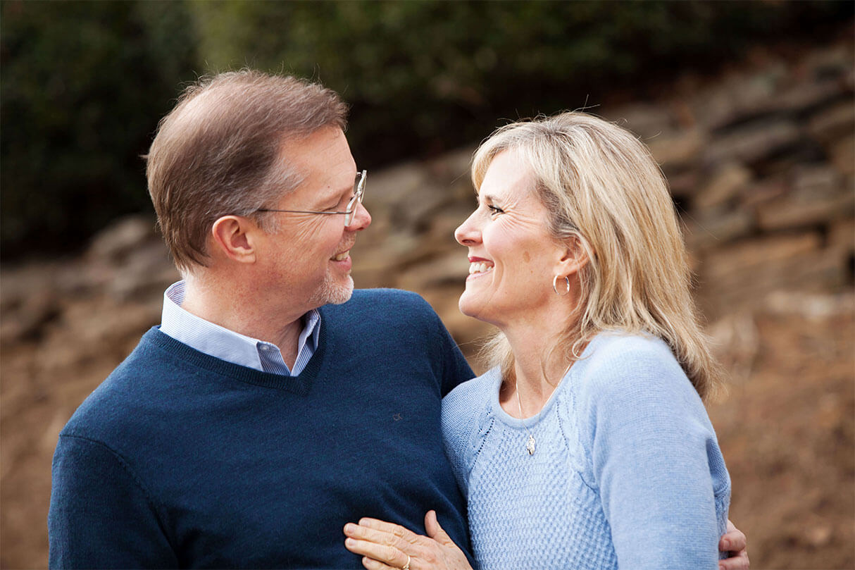 Ron Deal and his wife Nan Deal smiling at each other.