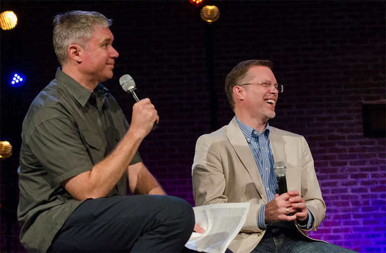 Ron Deal talking with a gentleman at a conference.